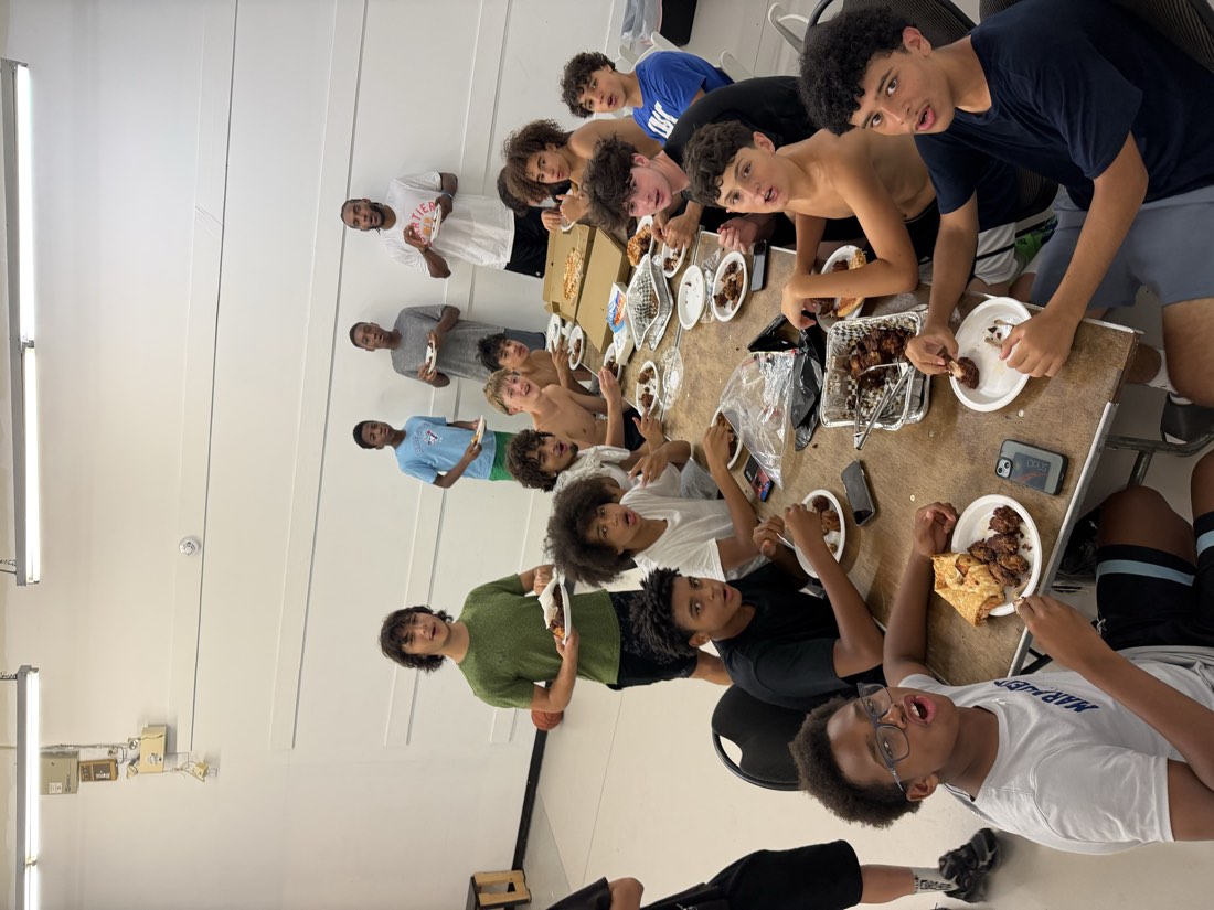 Athletes and coaches sharing a meal on the last day of Summer Grind Flu